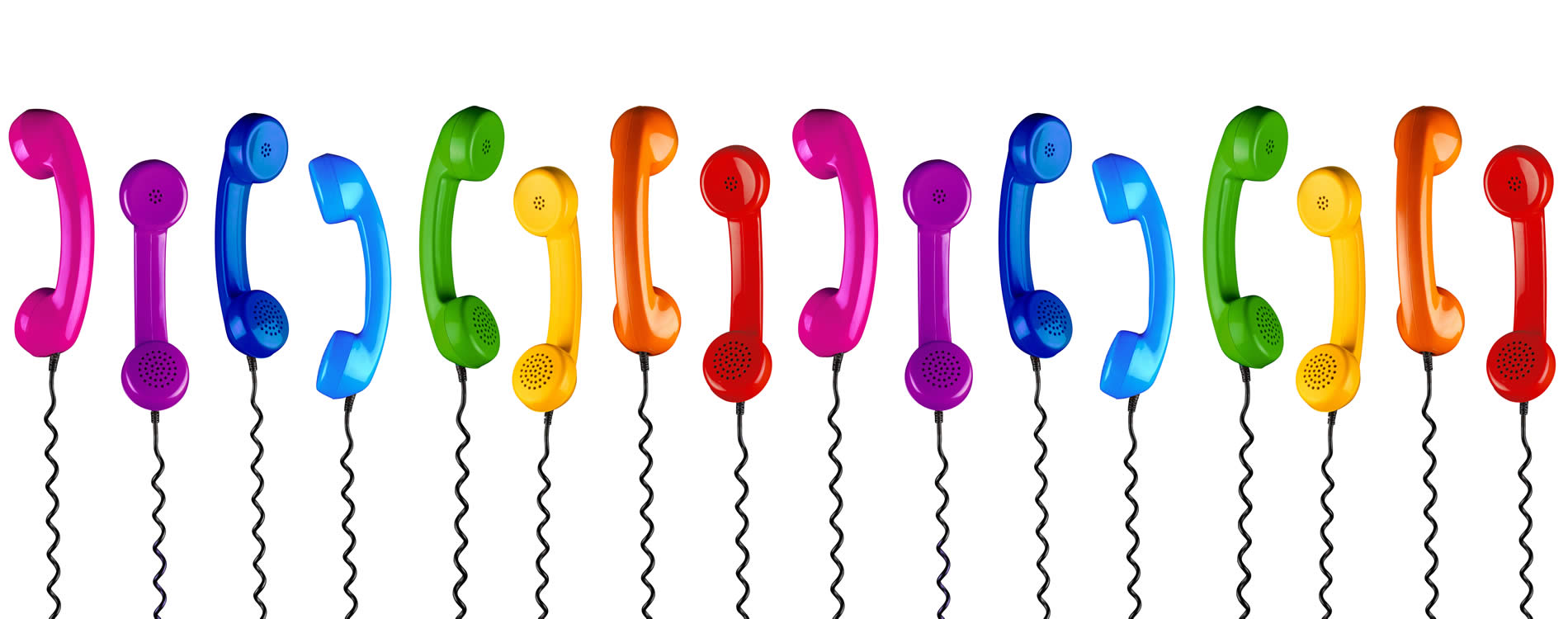 Colourful telephone handsets in a row